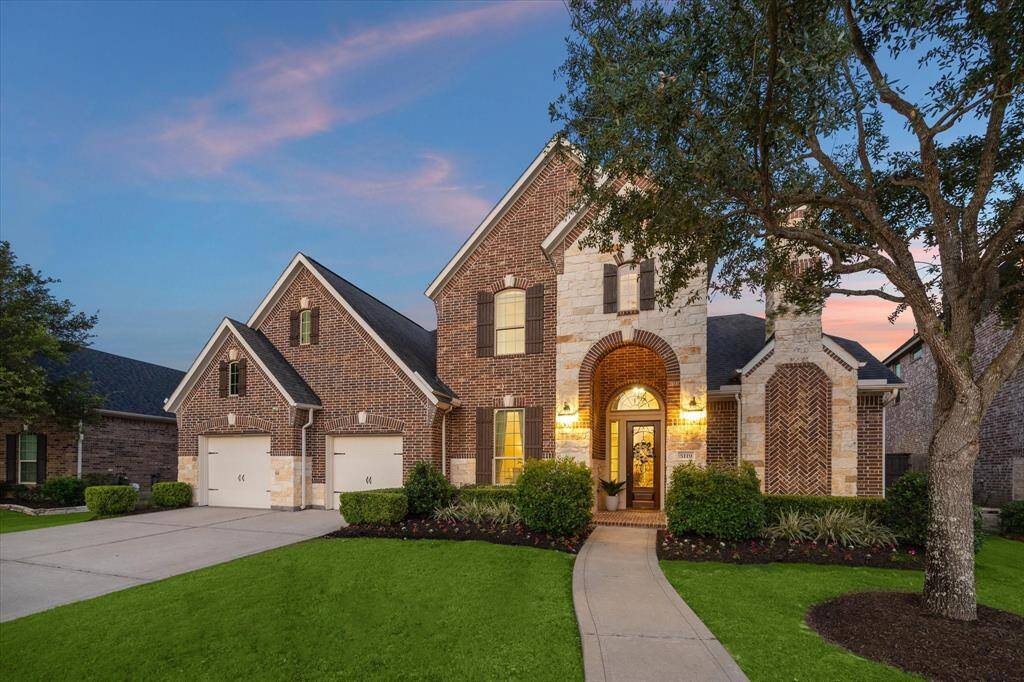 Gorgeous stone & brick front elevation on this 5 bed, 4.5 bath home with a 3 car garage and no back door neighbors.