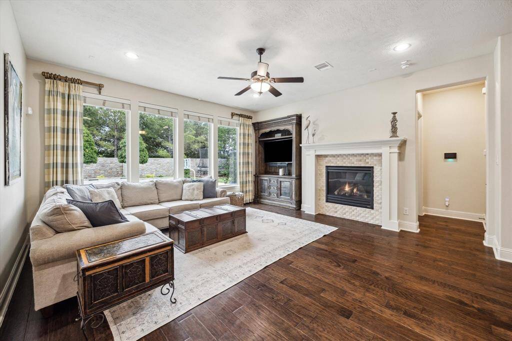 Stunning quartz countertops and designer light fixtures are a showstopper in this gourmet kitchen.