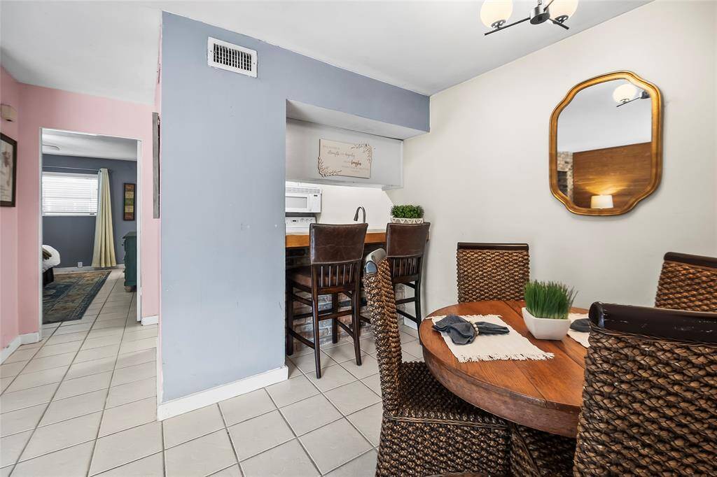 The dining room has extra bar height seating overlooking the kitchen.