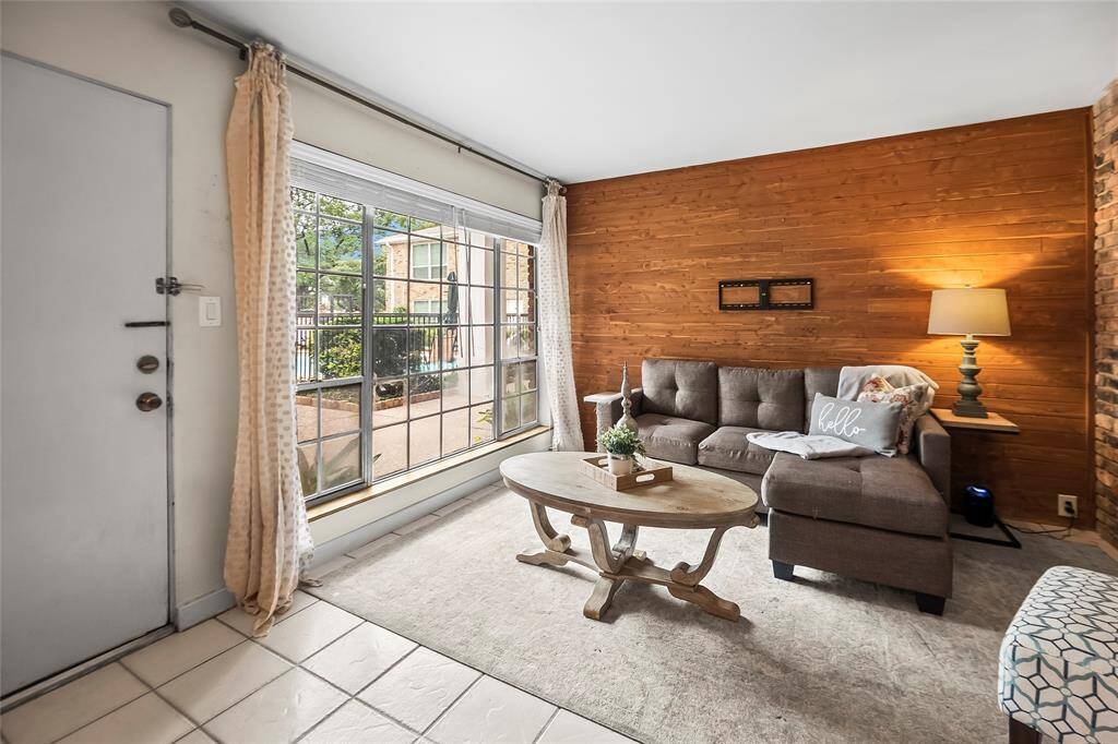 Alternate view of the living room with a view of the community pool.