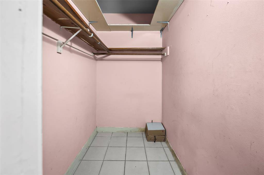 The main closet has hanging space and shelves.