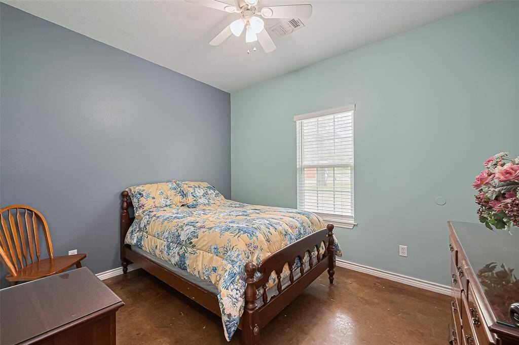Complemented by a ceiling fan and a large window, this serene space is restful and bright.