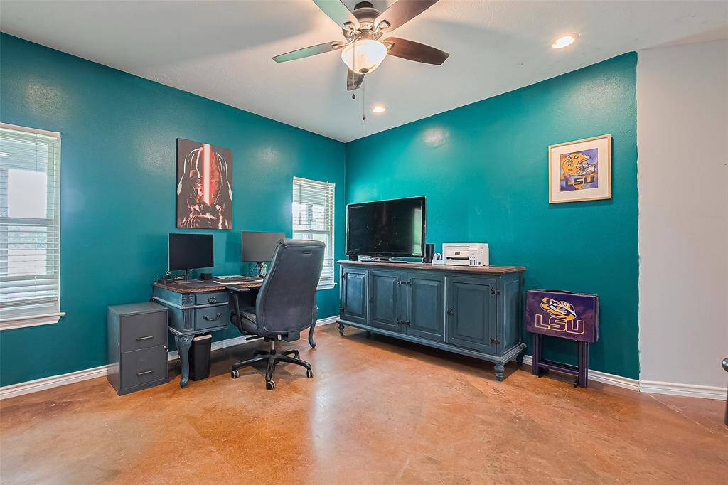 With bold blue-green walls and glossy concrete flooring, this vibrant workspace is as inspiring as it is practical.