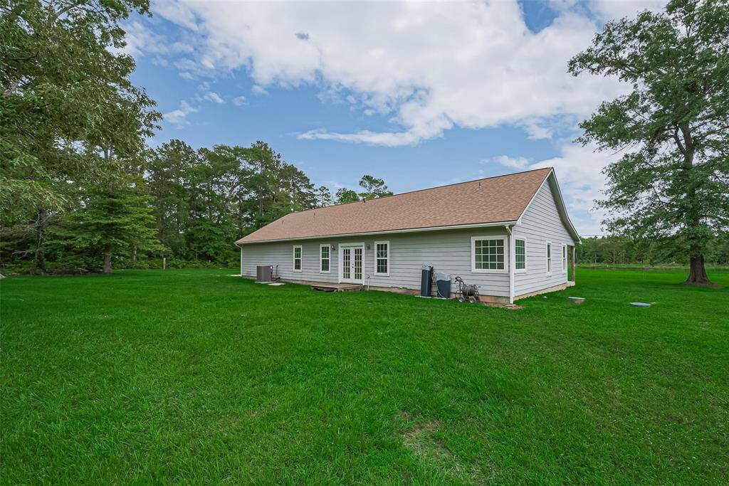 Framed by expansive grass and a treed backdrop, the rear of the home offers plenty of room to roam and relax.