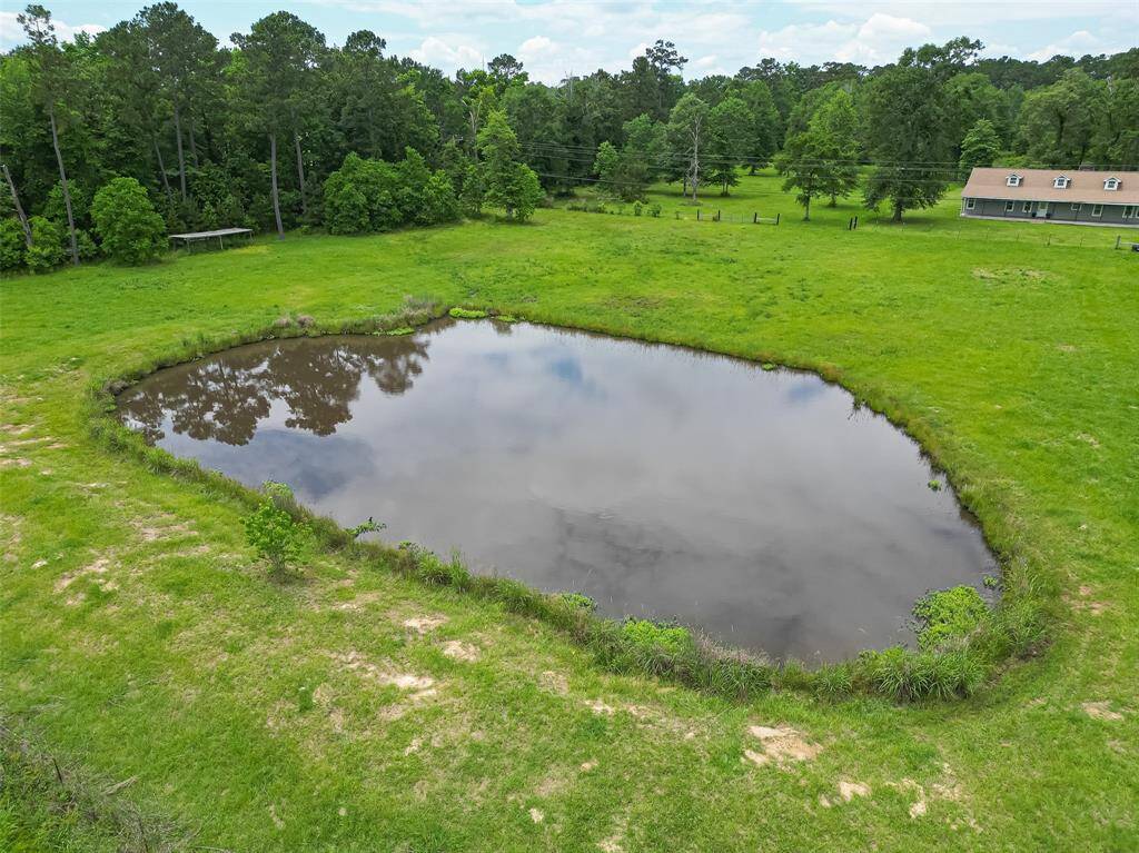 Tranquil and scenic, the stocked pond by the front of the land adds to the rustic beauty and provides a peaceful place to unwind.
