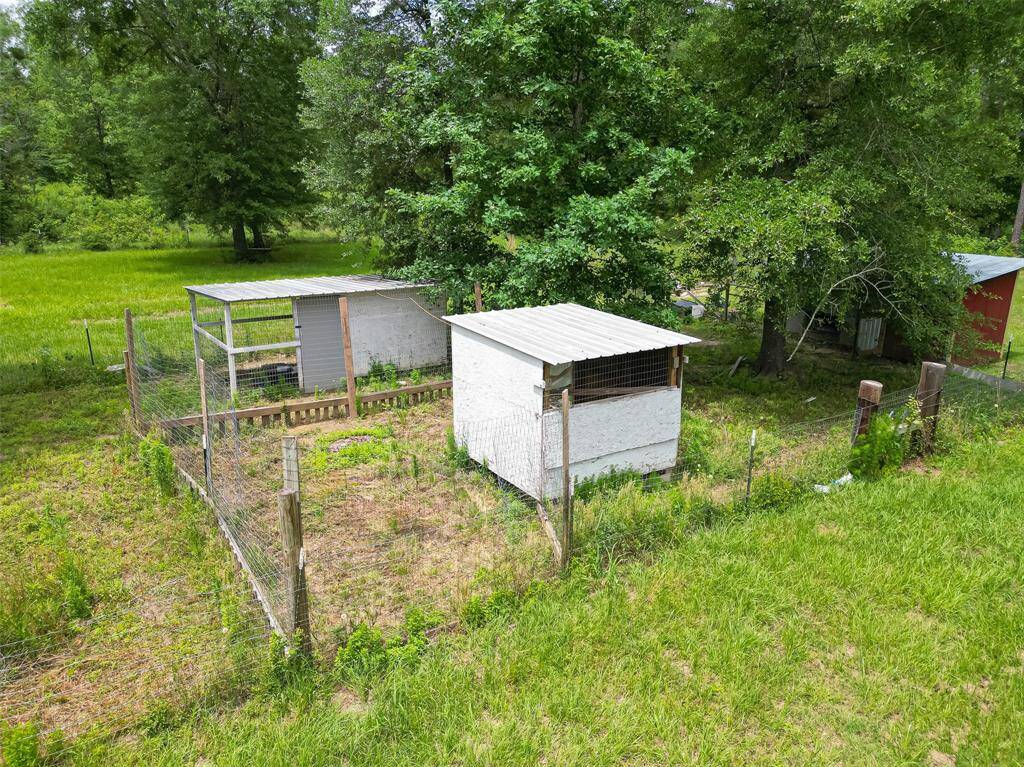 Additional enclosures with wire fencing and sheds currently used as chicken and duck coup.