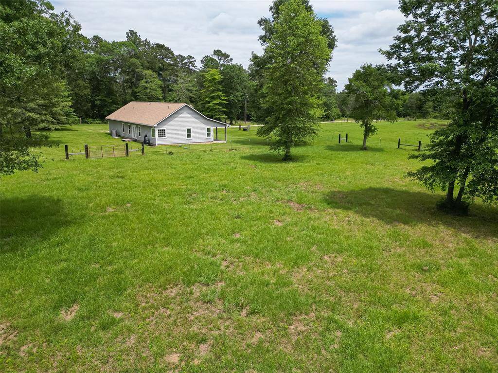 Another broad view captures the home from afar, with natural surroundings that enhance its secluded feel.