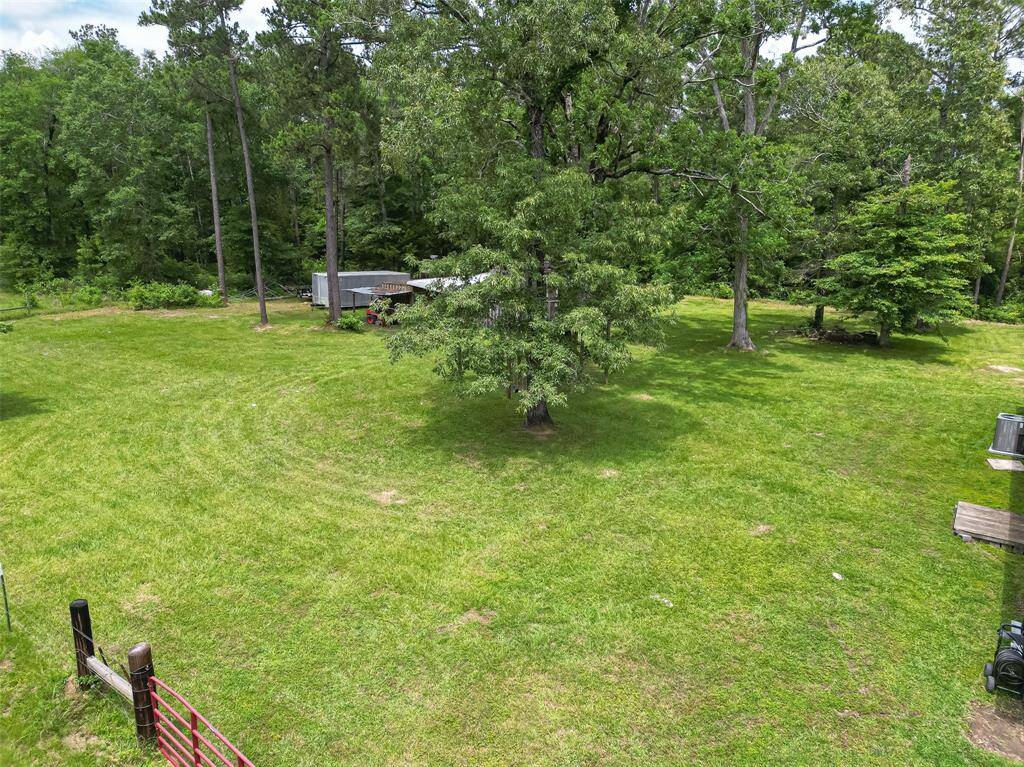 This aerial captures one of the property’s partially wooded areas, highlighting its blend of usable land and natural coverage.