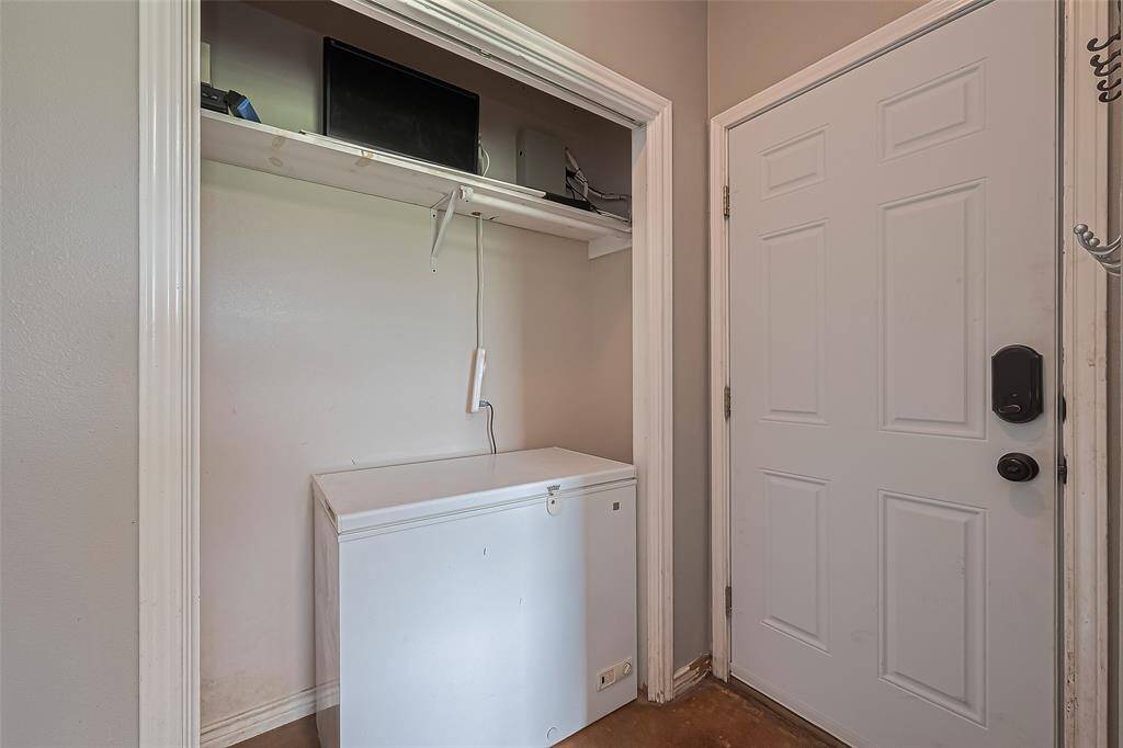 Functionality meets simplicity in the utility room, featuring a recessed storage nook perfect for sorting and organizing.