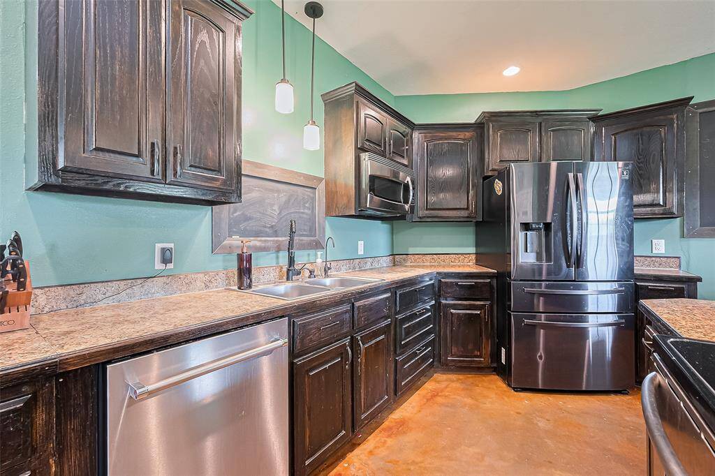Equipped with stainless steel appliances and generous counter space, this kitchen is both stylish and practical.