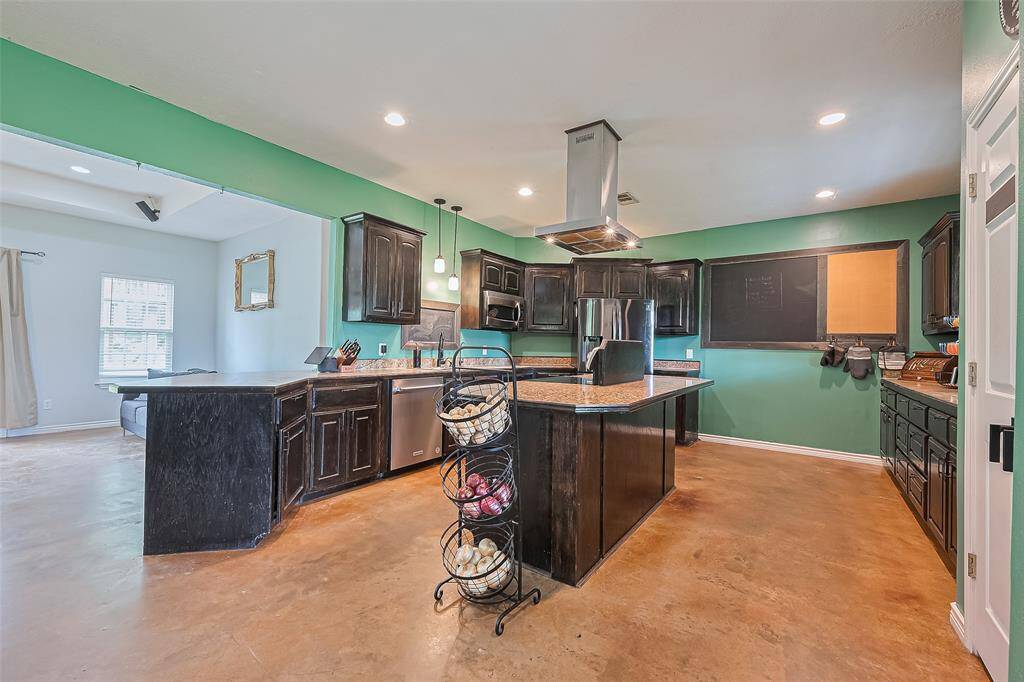 An open flow from the kitchen to the living room ensures easy conversation and a welcoming environment for gatherings.