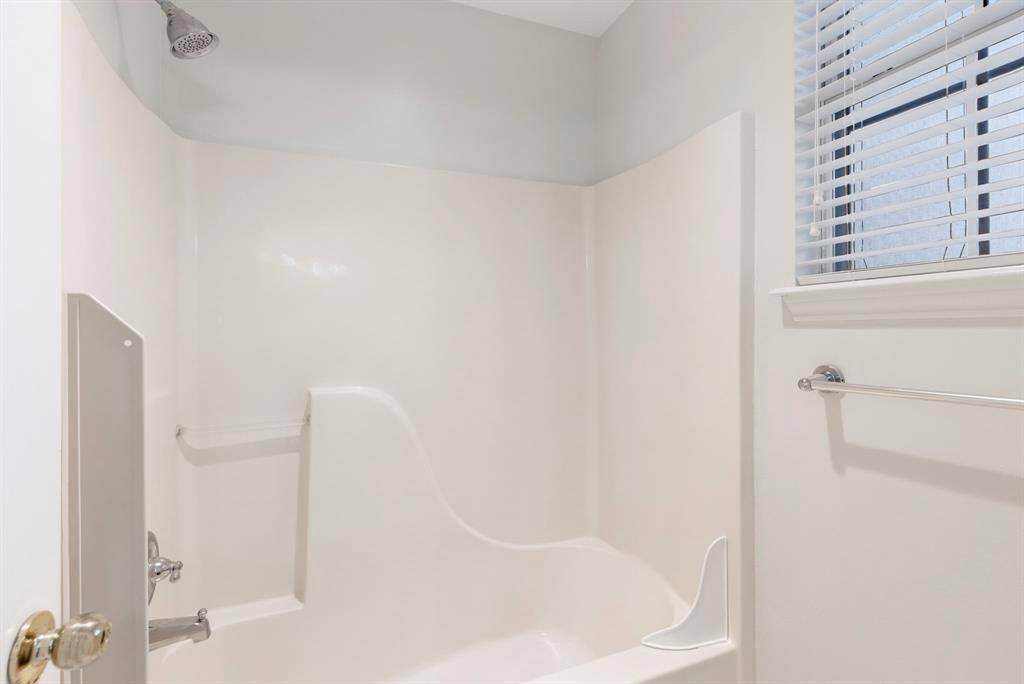 The secondary bathroom on the second floor is equipped with a shower/tub combo.