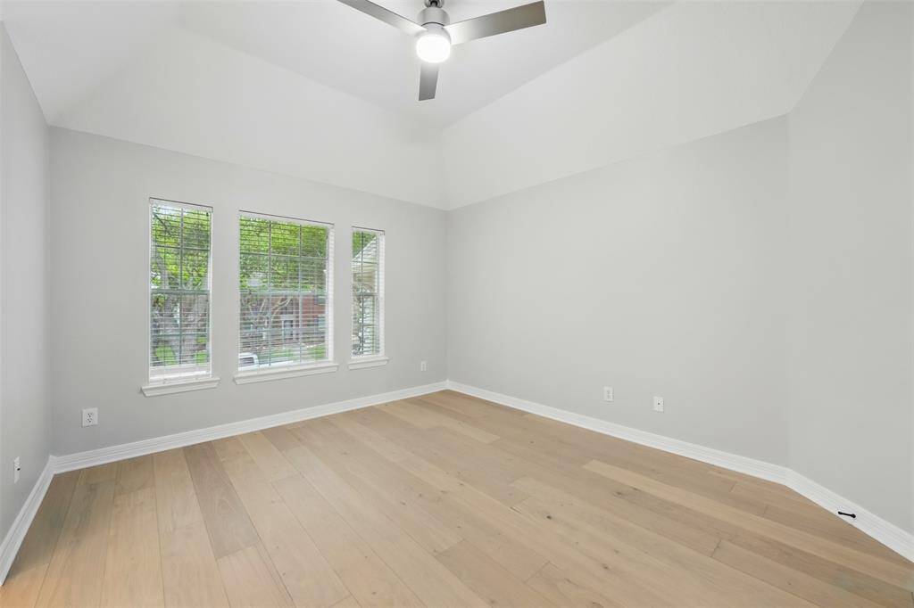 Spacious upstairs bedroom with abundant natural light.