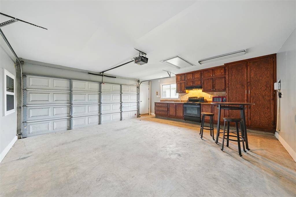 This garage features a fully equipped kitchen, offering convenience and versatility for entertaining or additional workspace.