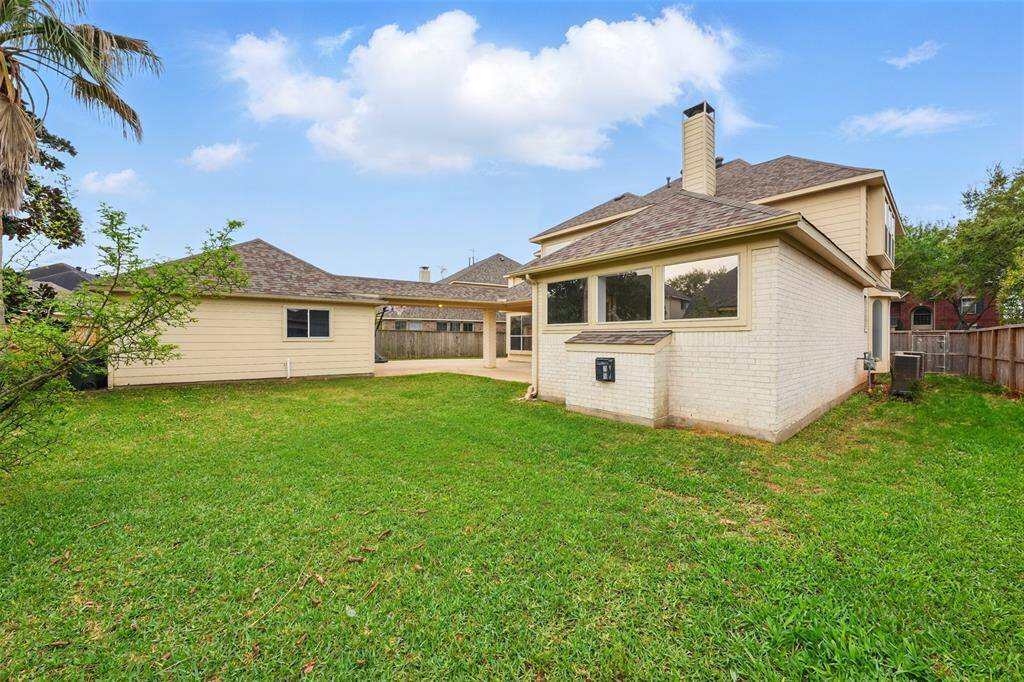 Spacious backyard with lush grass, perfect for outdoor activities and relaxation. Enjoy privacy and tranquility in this charming outdoor space.