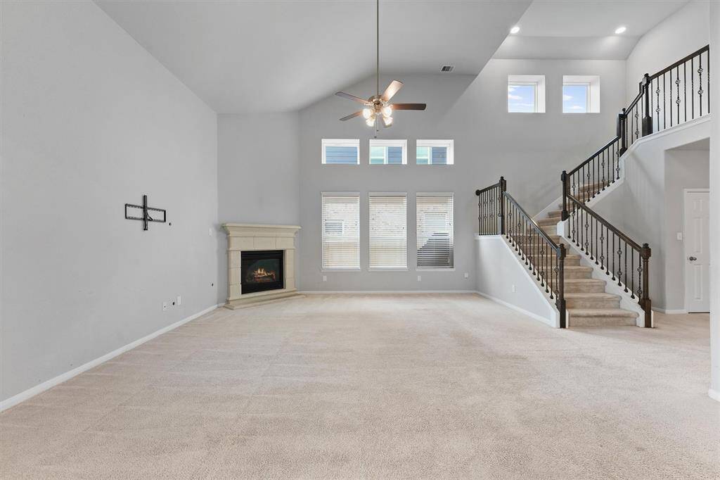 Large Living Room with tall ceilings and a fireplace.