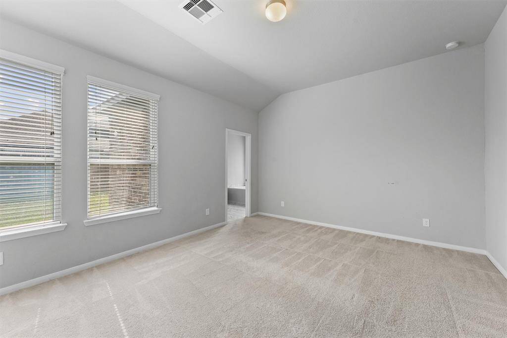Primary bedroom with lots of natural light.