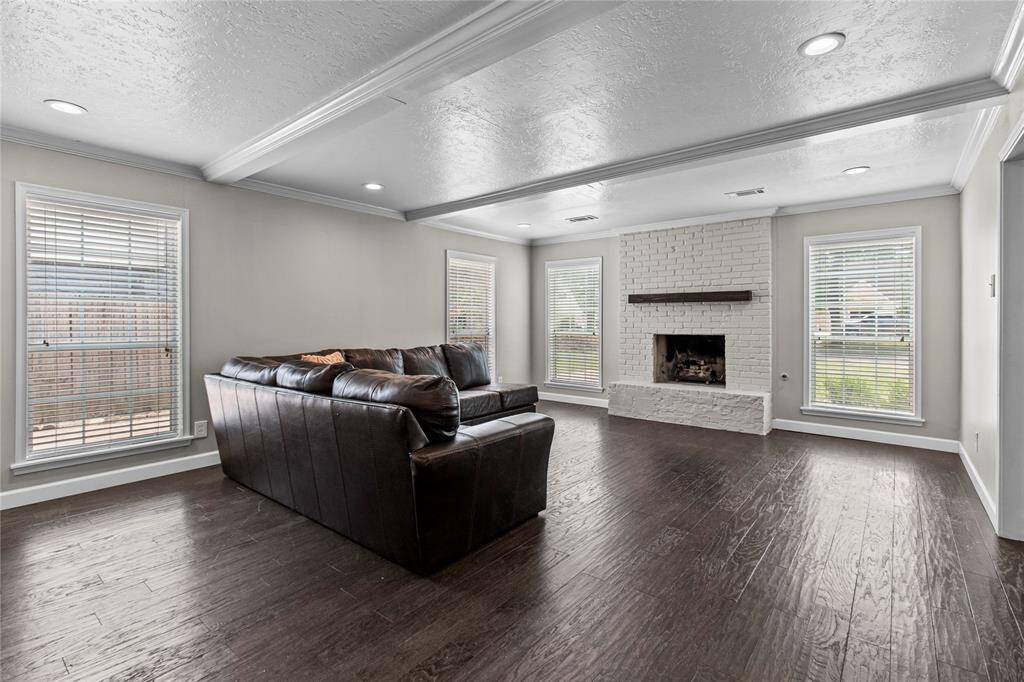 The living room is large and can accommodate any furniture configuration.