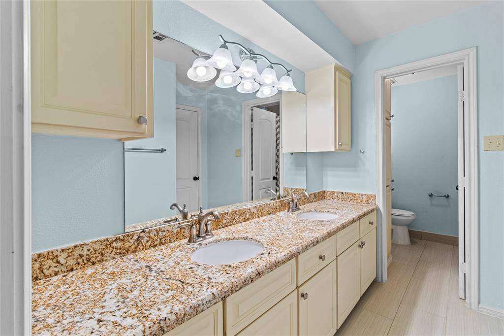 The second full bathroom is accessible to all secondary bedrooms and has double sinks and a separate room with the tub/shower and toilet.