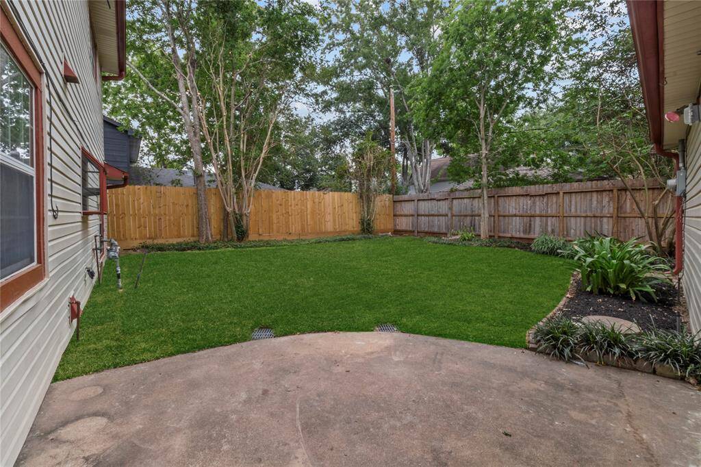 The back yard has fresh grass and is fully fenced.