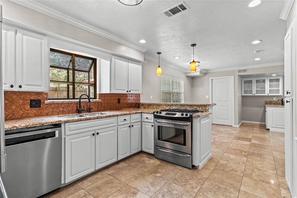 The kitchen has granite counter tops, a copper back splash and real wood cabinetry.