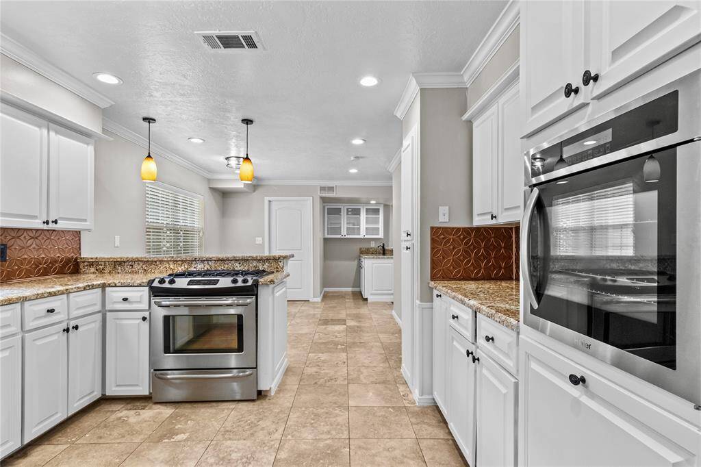 The kitchens features all stainless steel appliances and double ovens.