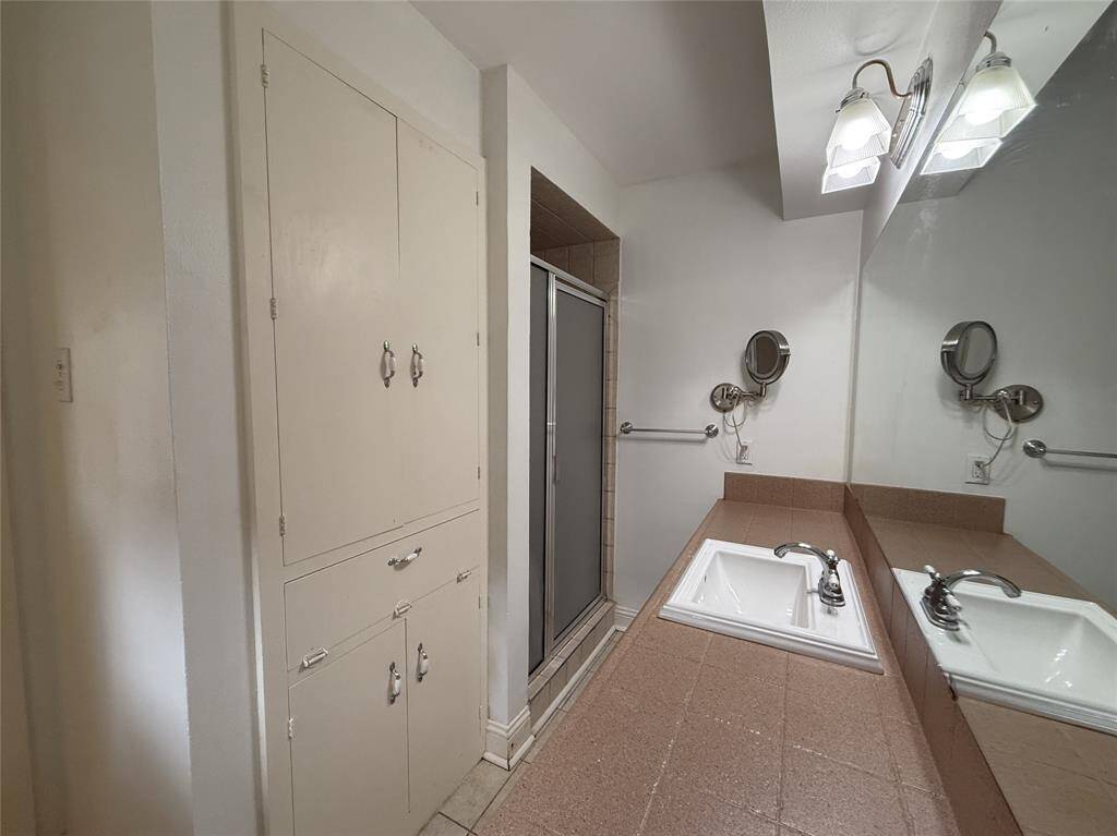 The primary bath offers a shower, linen closet & built-in hamper.