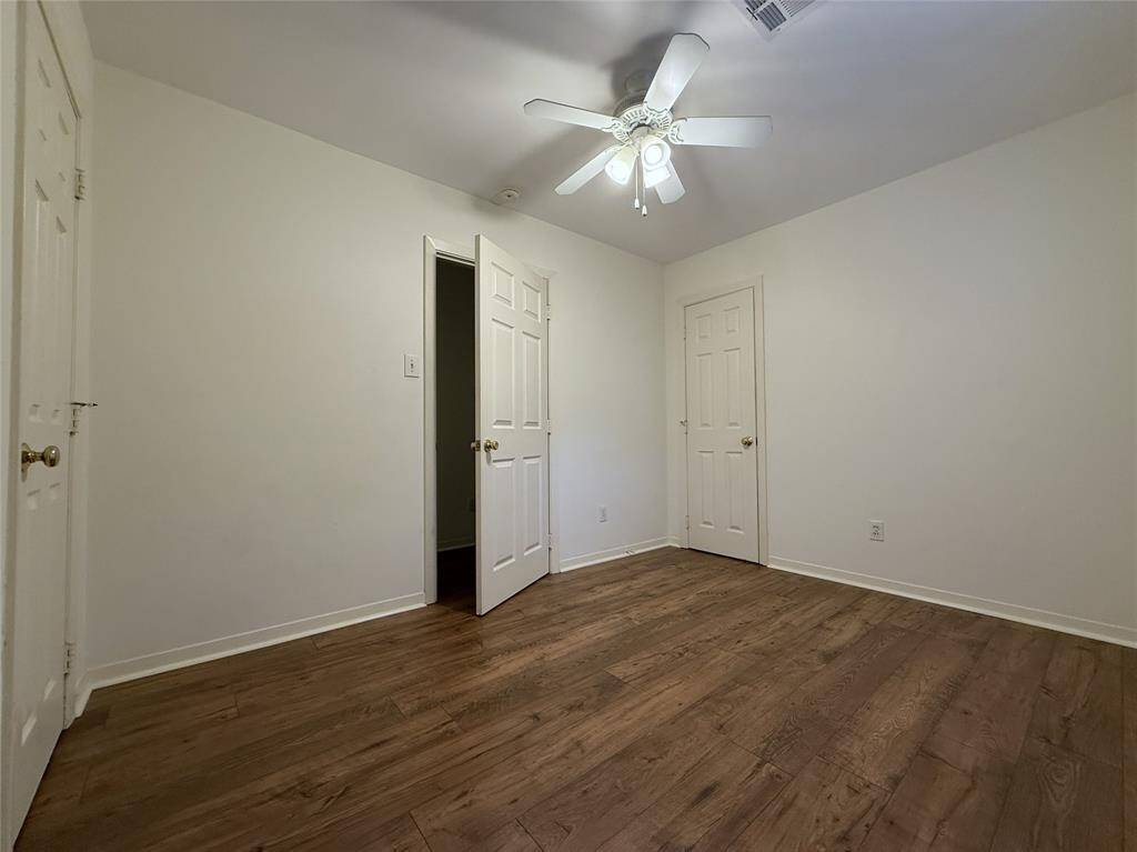 With ceiling fan, the center bedroom offers two closets.