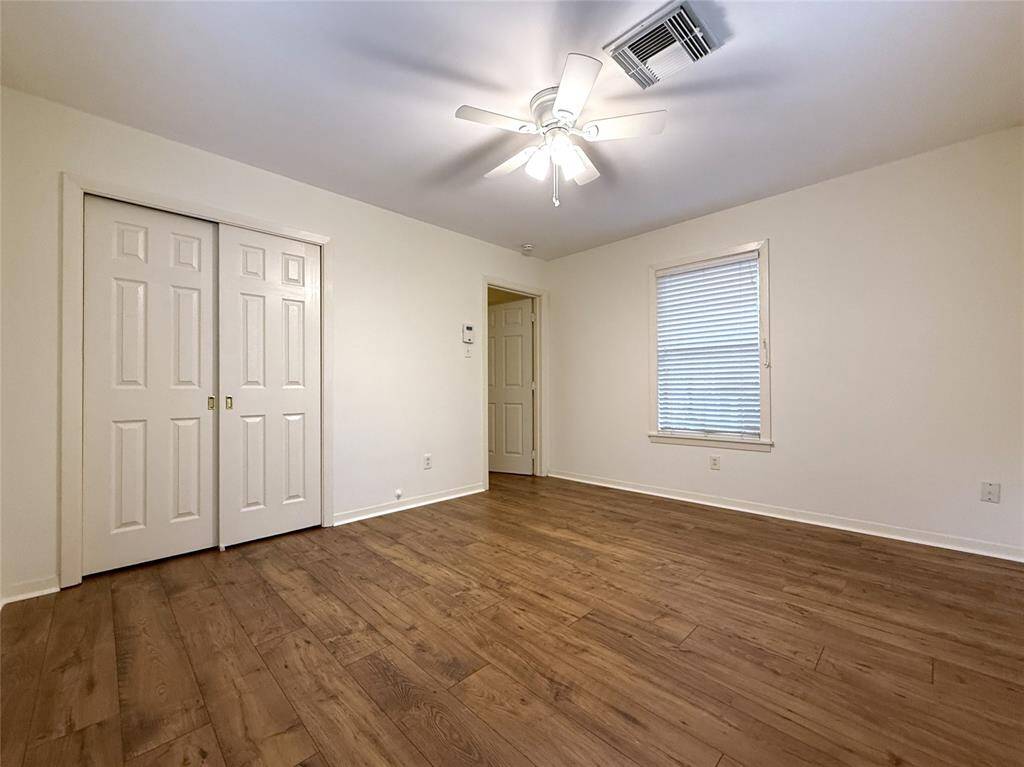 Alternate view of the back bedroom. On the opposite side, the window offers a view out onto the brick patio.