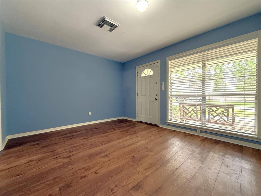 Finished in a soothing shade of blue, the formal living room features a picture window & view out to the tree lined neighborhood.