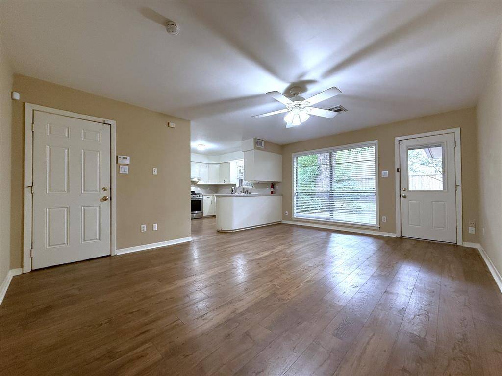 The dining/family combo room features a picture window & view out onto the brick patio & beyond to the back yard. Past the door on the left is the attached garage & laundry area.
