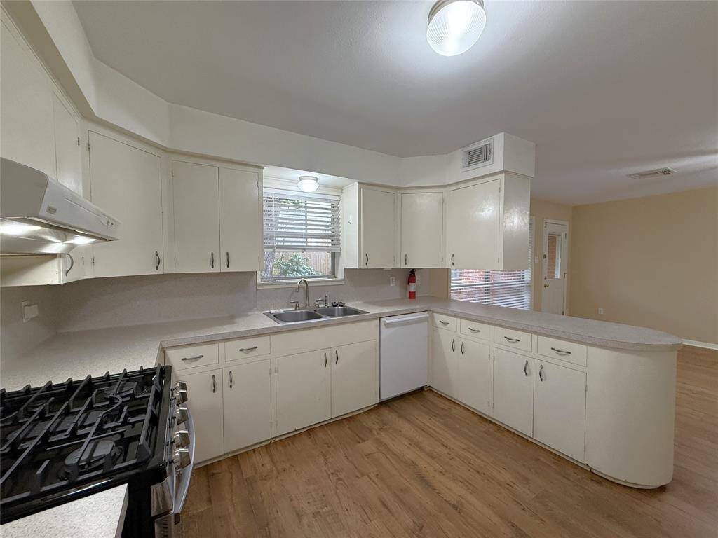 Look at all that cabinet & counter space! Natural light flows in front the window above the sink. Yes, of course there is a dishwasher!