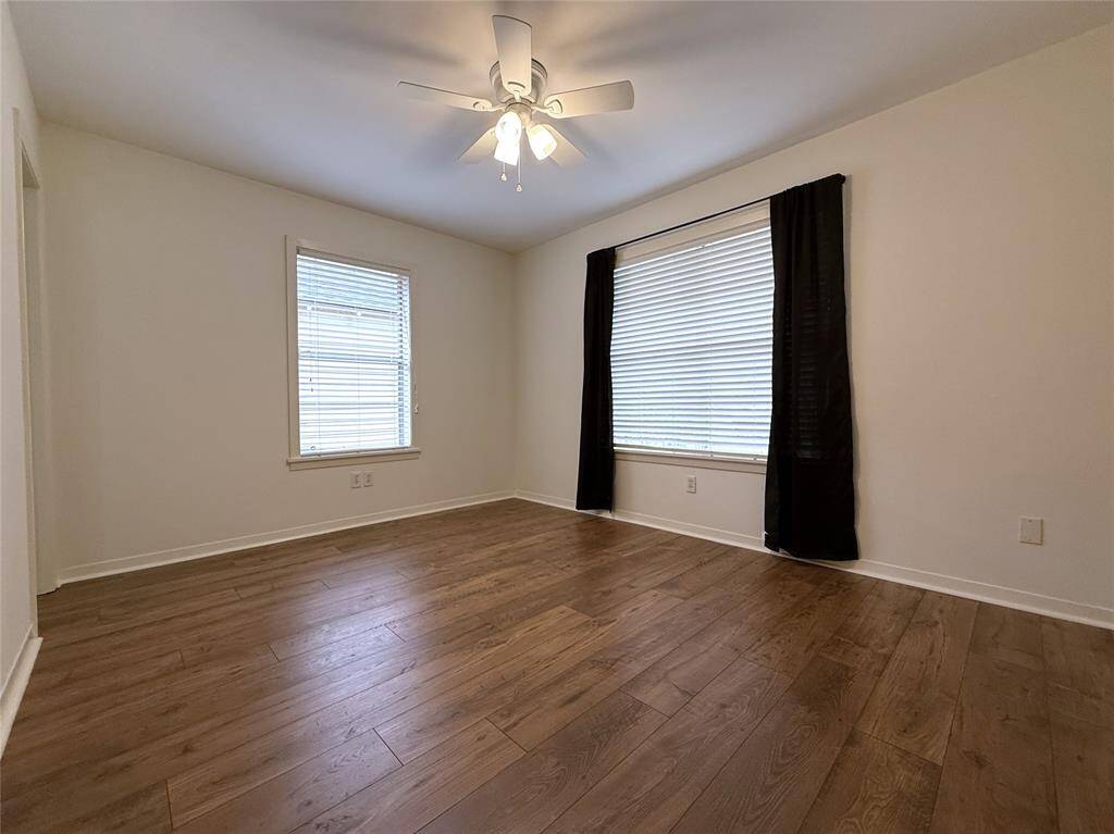 The front/primary bedroom with ceiling fan.