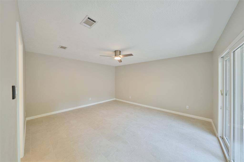Very Spacious Primary Bedroom! This room has plenty of natural light with sliding glass doors onto the deck.