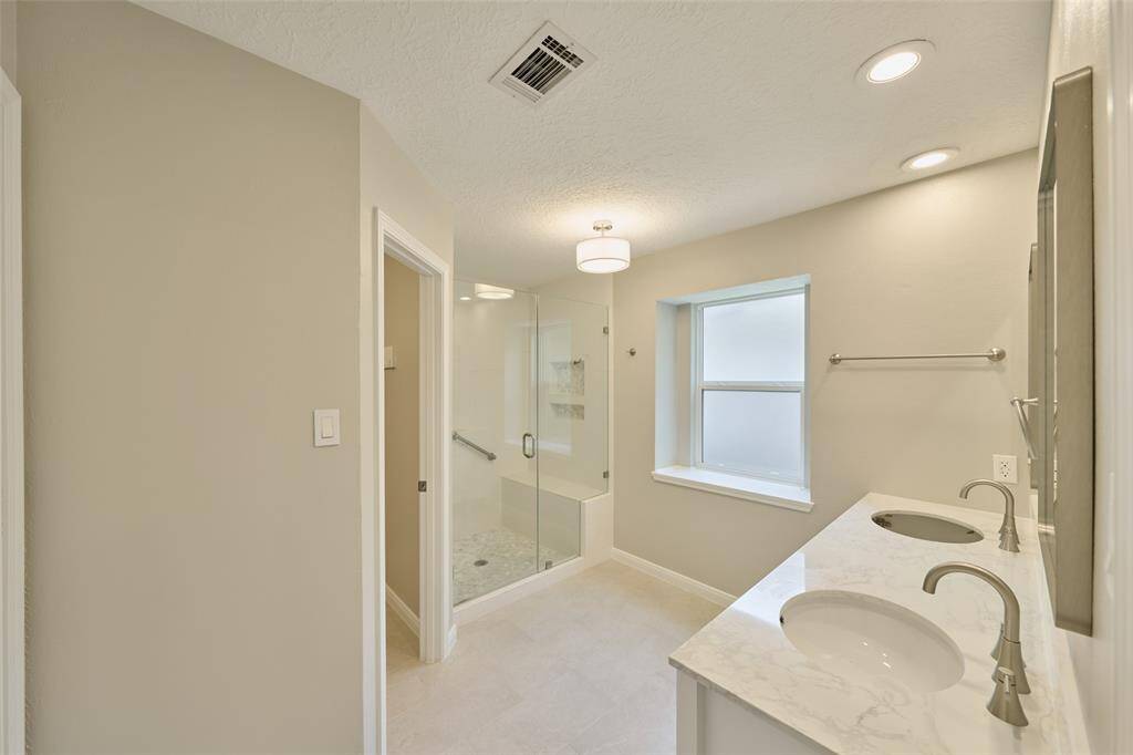 Primary Bath with complete remodel. Large walk in shower with seat. Oversized closet space as well as tons of light.
