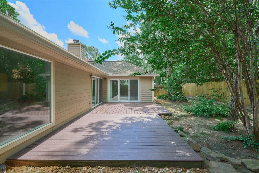 Large deck area and beautiful mature landscaping.