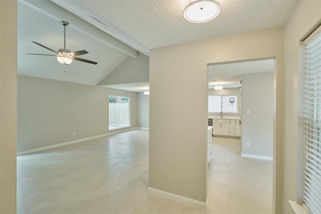 Enter into the open living and kitchen area. All fresh paint, flooring, cabinets, quartz countertops, new lighting/fans and SS appliances!