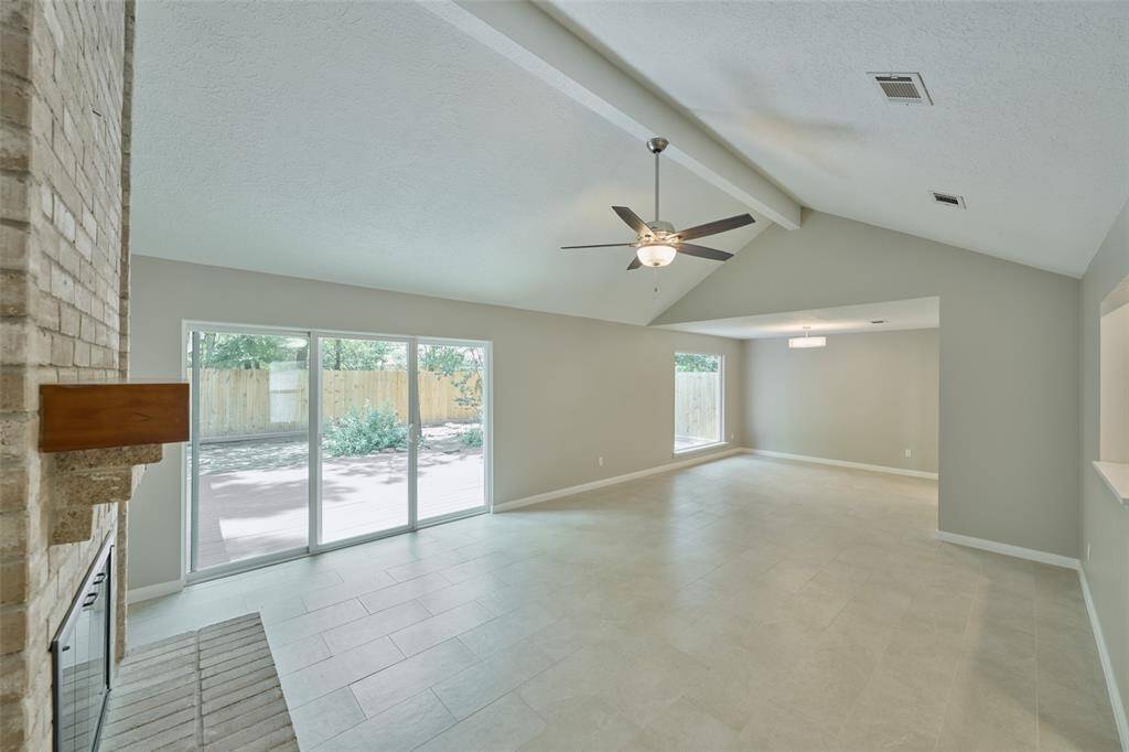 Vaulted living room with adjacent dining and tons of natural light from multiple windows and sliding glass doors. Brand new fencing and tons of privacy with this layout.