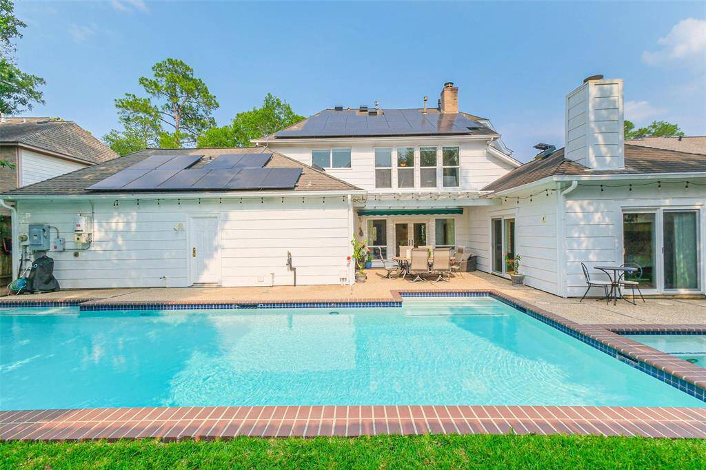 Step into the backyard oasis with a relaxing pool and spa.