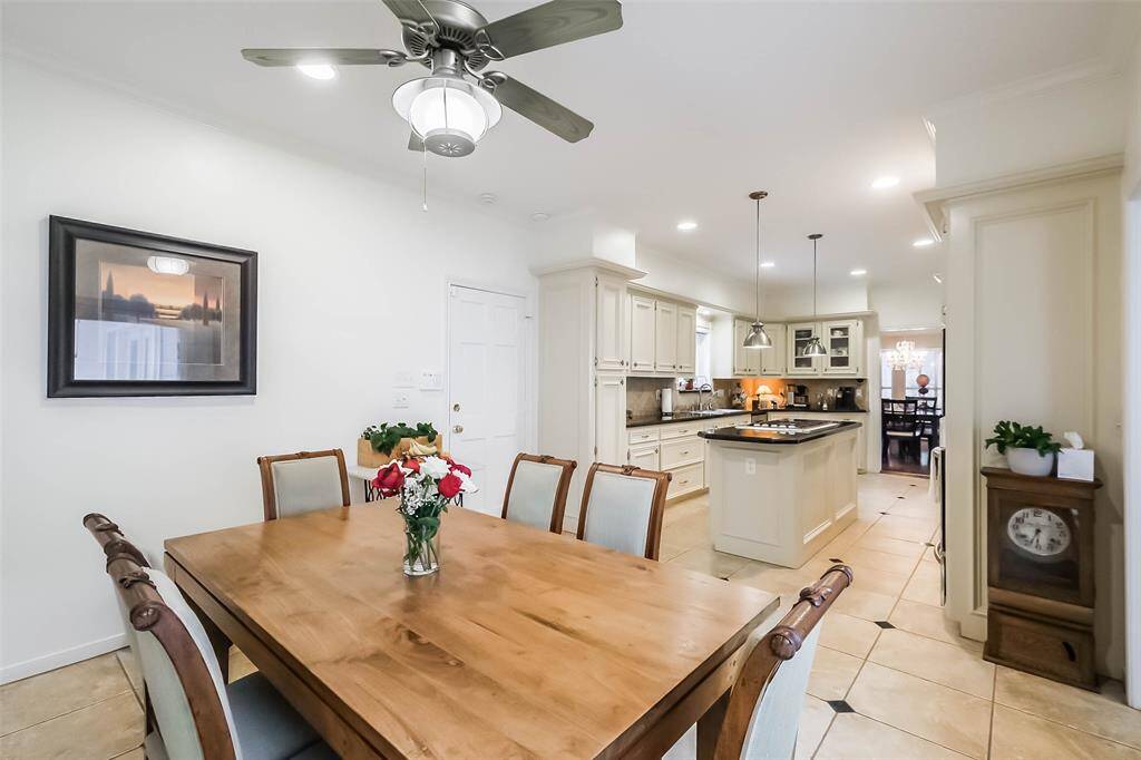 The breakfast room features tile floors and a ceiling fan.