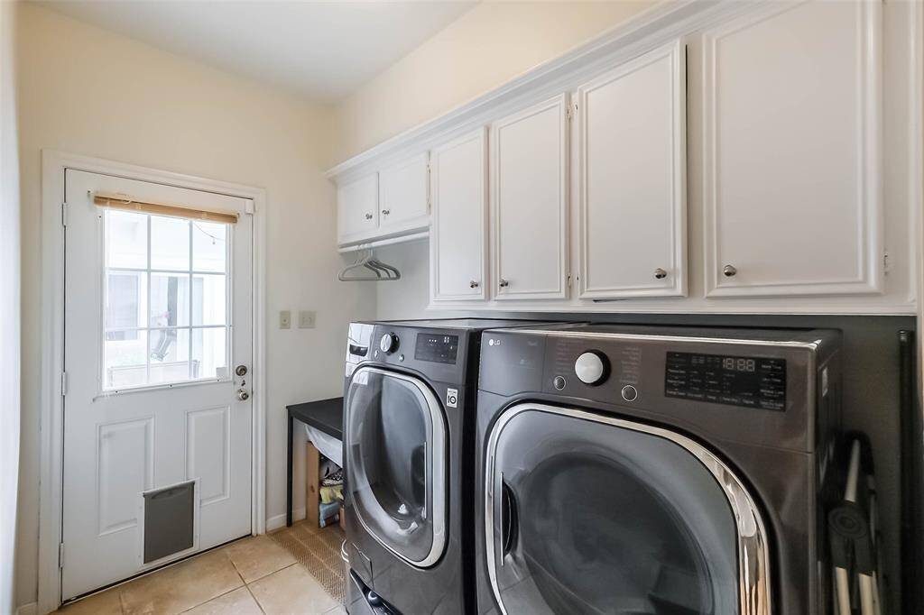 The laundry room features tile floors,washer and dryer connections, andplenty of storage space.