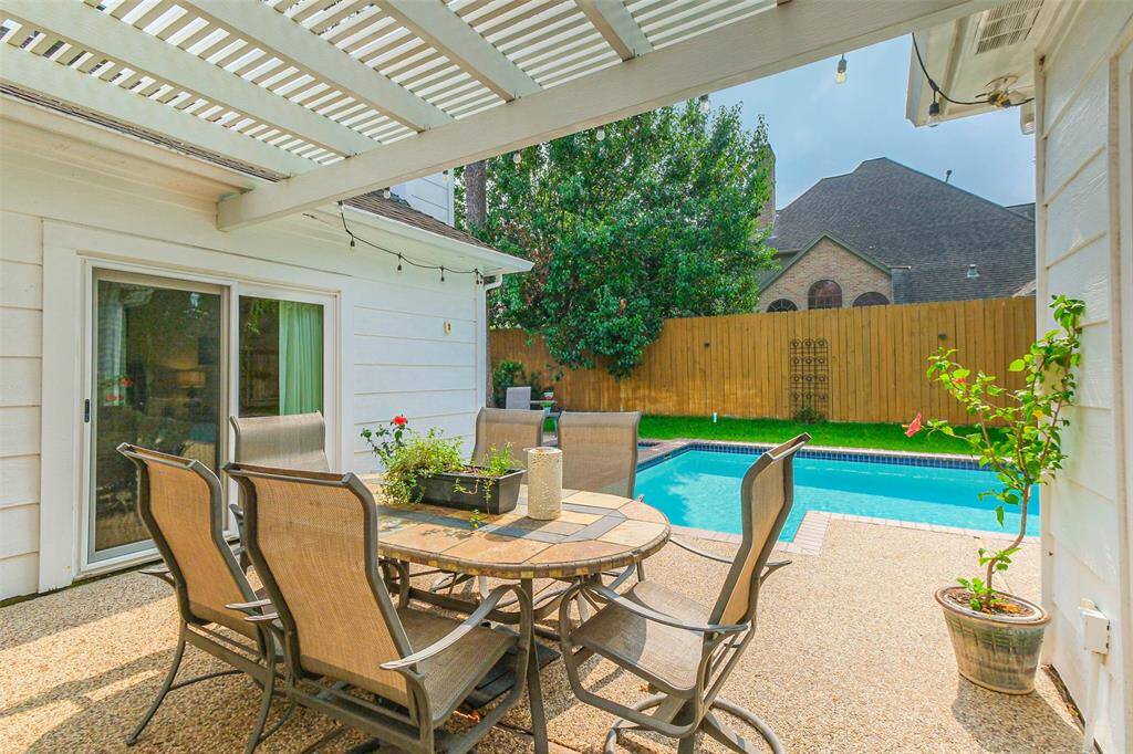 Step into the backyard oasis, with a covered patio, creating aninviting outdoor retreat. There is also a remote controlled awning with lights for additional shading if desired.