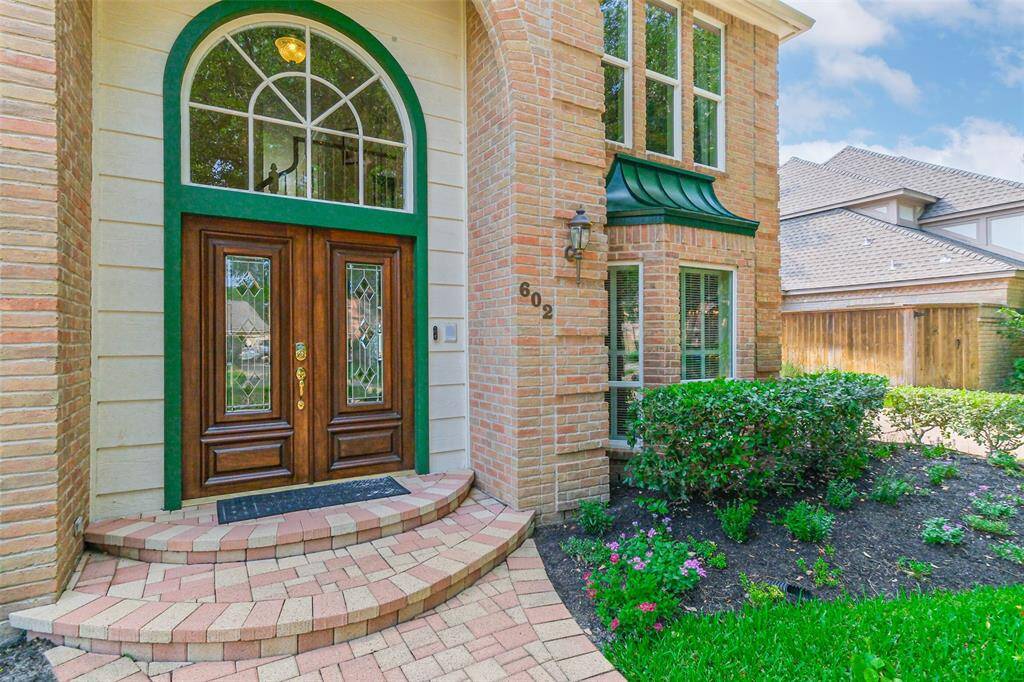 Approaching the front door is the brick paved walkway.