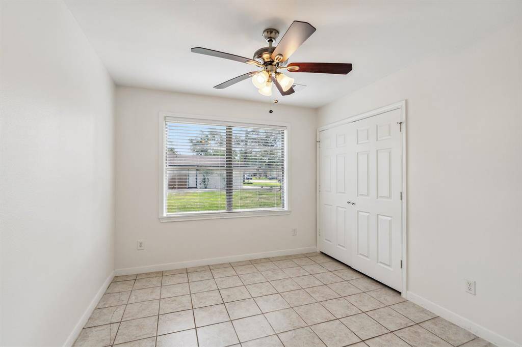 This spacious primary bedroom features two separate closets, offering ample storage and everyday convenience. A large window provides Secondary bedroom #2. soft natural light while maintaining privacy.