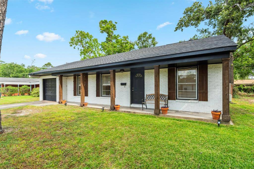 The inviting curb appeal is enhanced by a brick exterior, dark accents, and mature trees that frame the spacious front yard. This quiet street is ideal for enjoying peaceful mornings or evening strolls.
