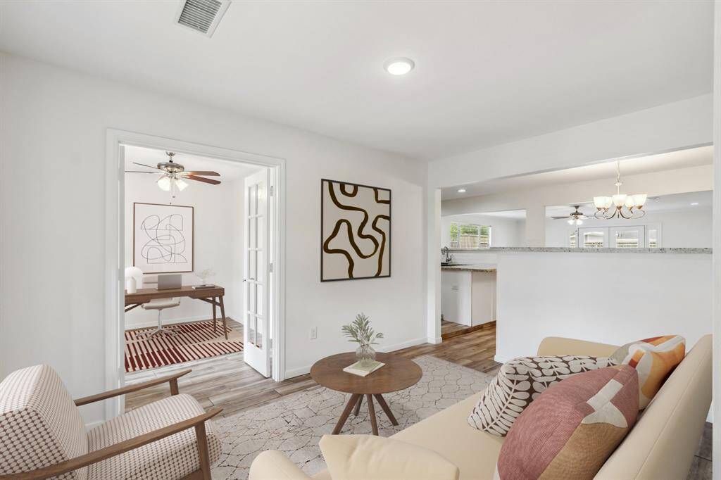 **Virtually Staged** Front living room just off the entryway — versatile space with potential! The wall separating it from the dining & kitchen areas could be easily removed to create a more open-concept floor plan, if desired. Buyer to verify.