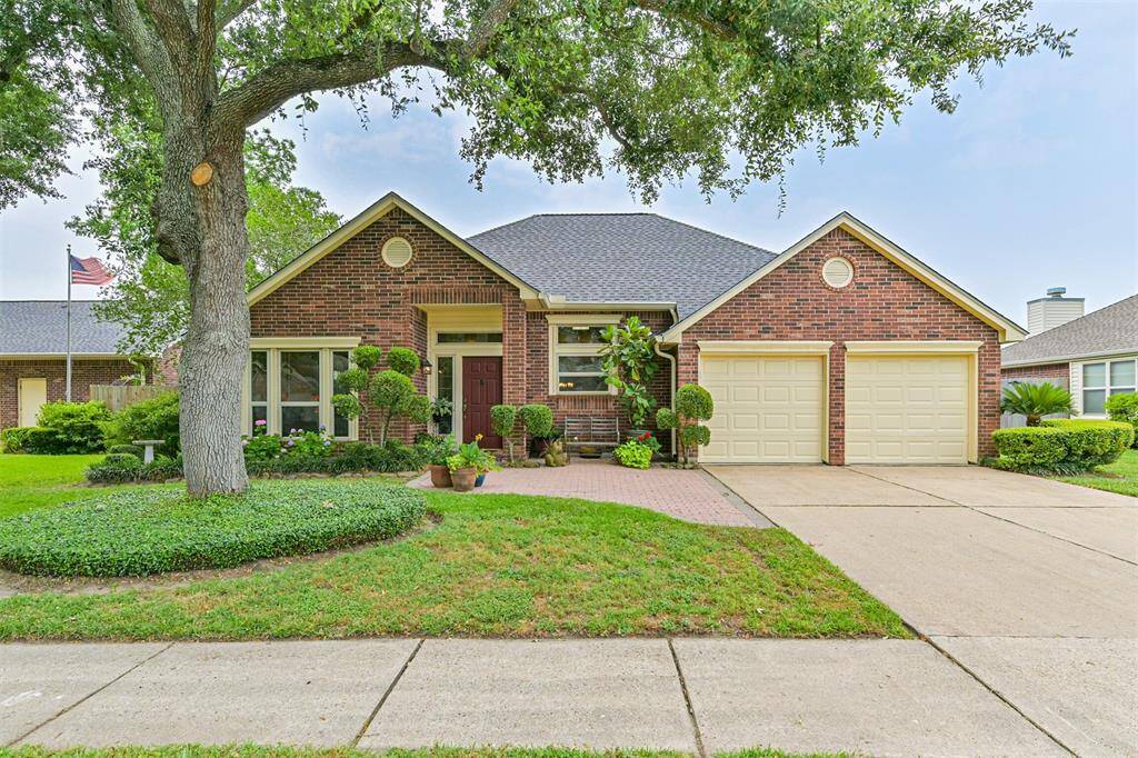 Charming curb appeal with mature trees and thoughtfully landscaped beds.