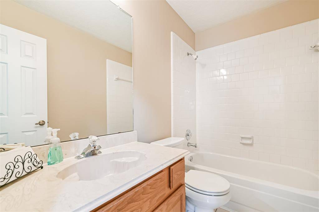 Hall Bath-Neutral tile and cabinetry make it easy to personalize.