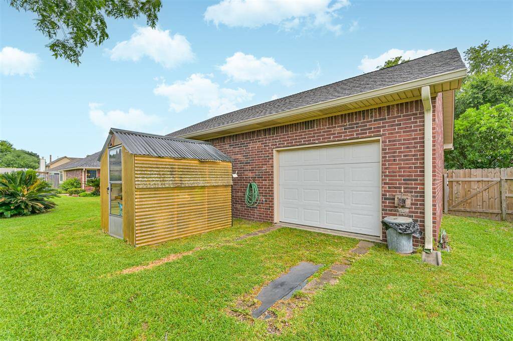 Rear garage door opens to the backyard, offering secure and private trailer access.