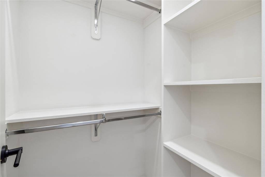 A well-appointed dressing area with clean design and ample storage solutions.